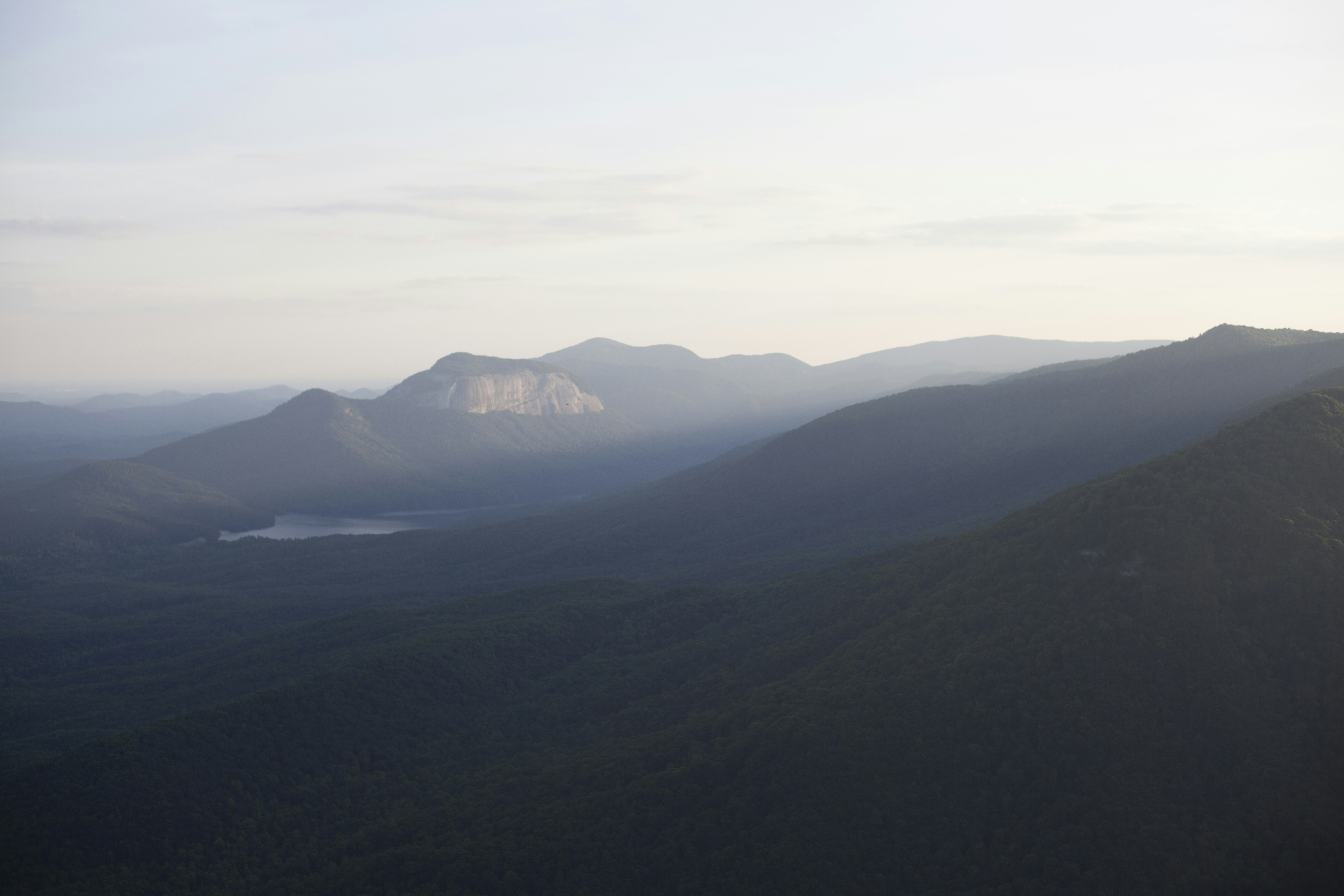 a view of a mountain range with a lake in the foreground