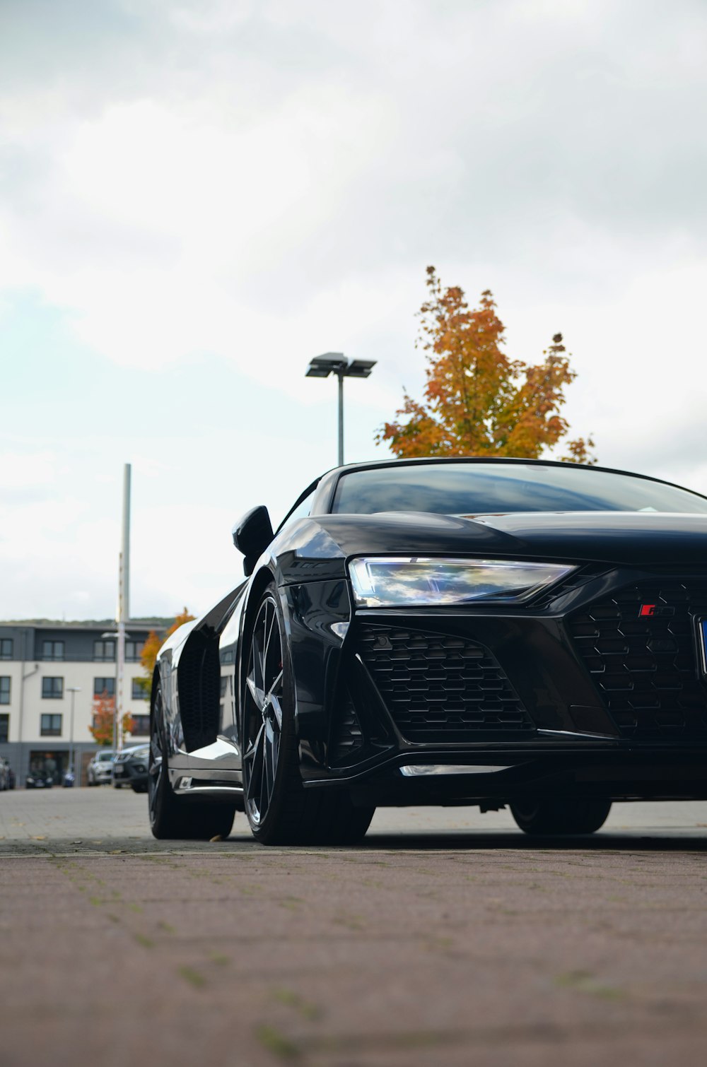 a black sports car parked in a parking lot