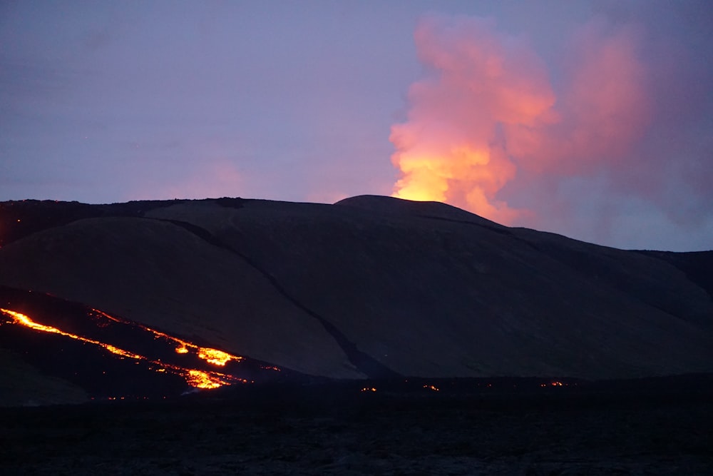 a fire blazing in the sky over a mountain