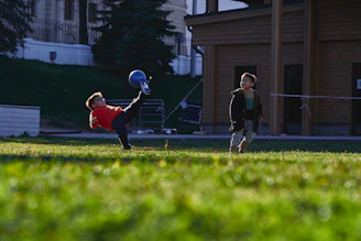 a small child swinging a bat at a ball