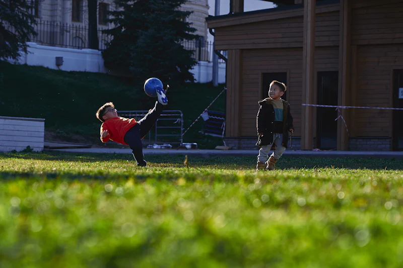 Red kickball on a grass field