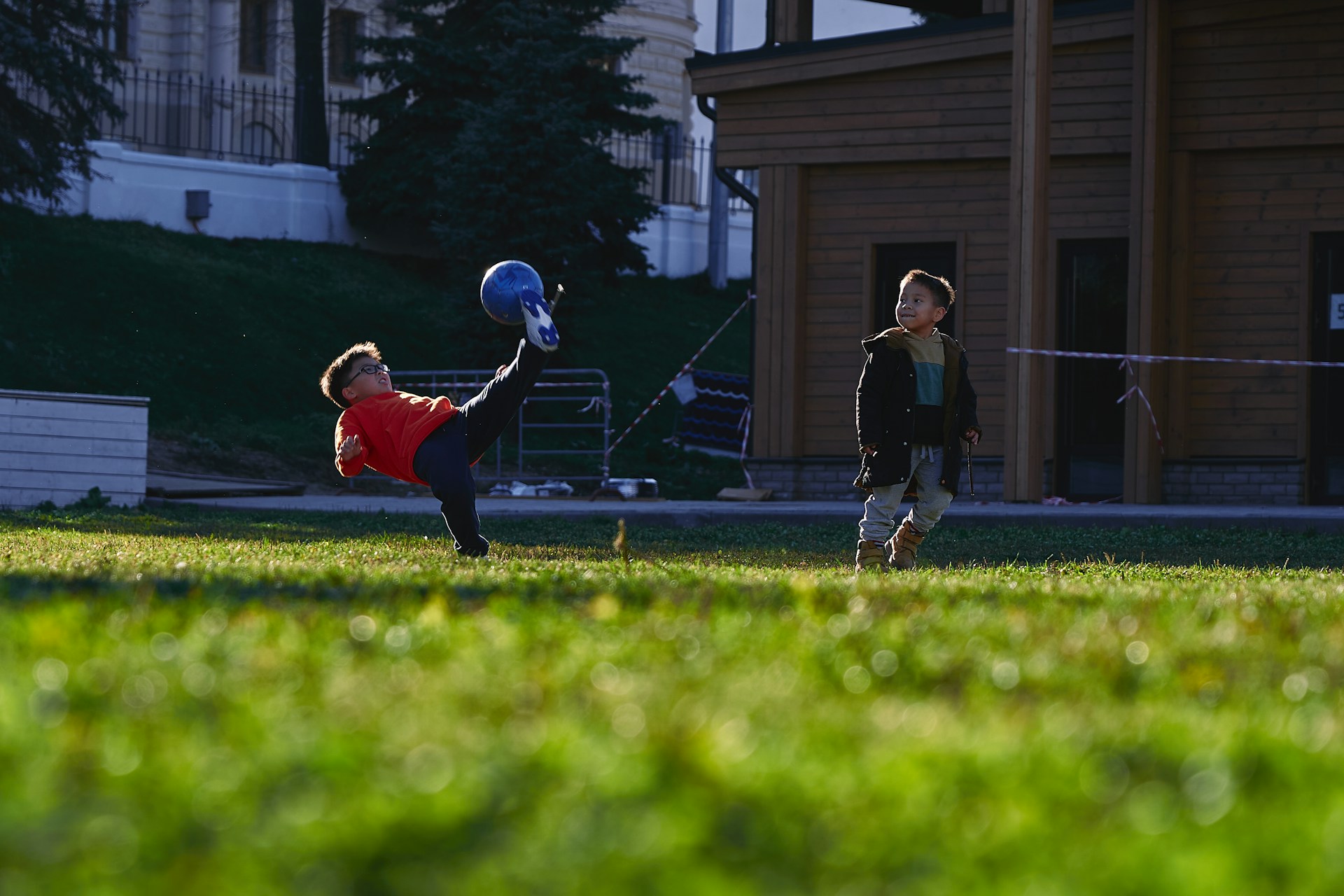 a small child swinging a bat at a ball