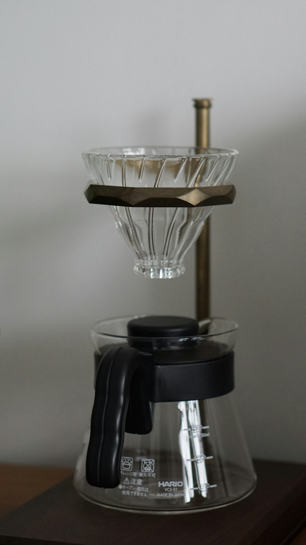 a coffee maker sitting on top of a wooden table