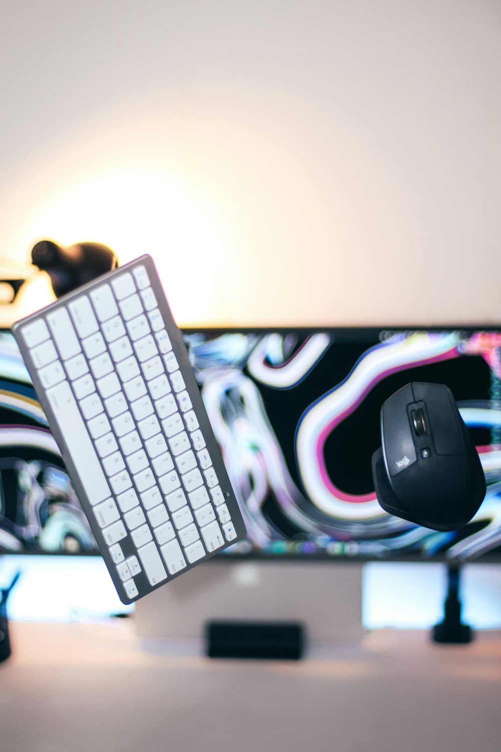 a computer keyboard and mouse on a desk