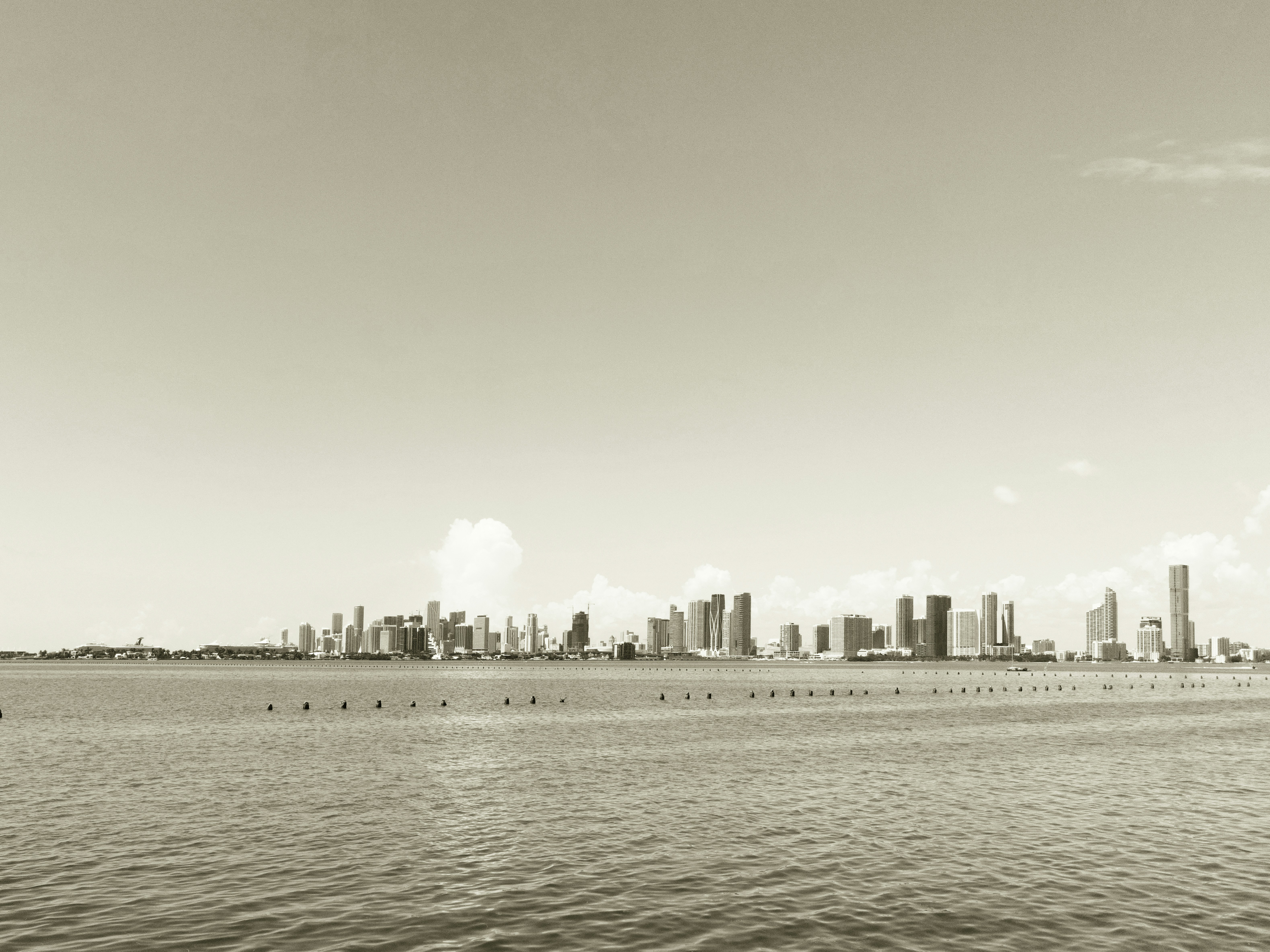 a large body of water with a city in the background