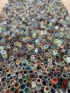 An artistic arrangement of glaze compounds in different containers.
