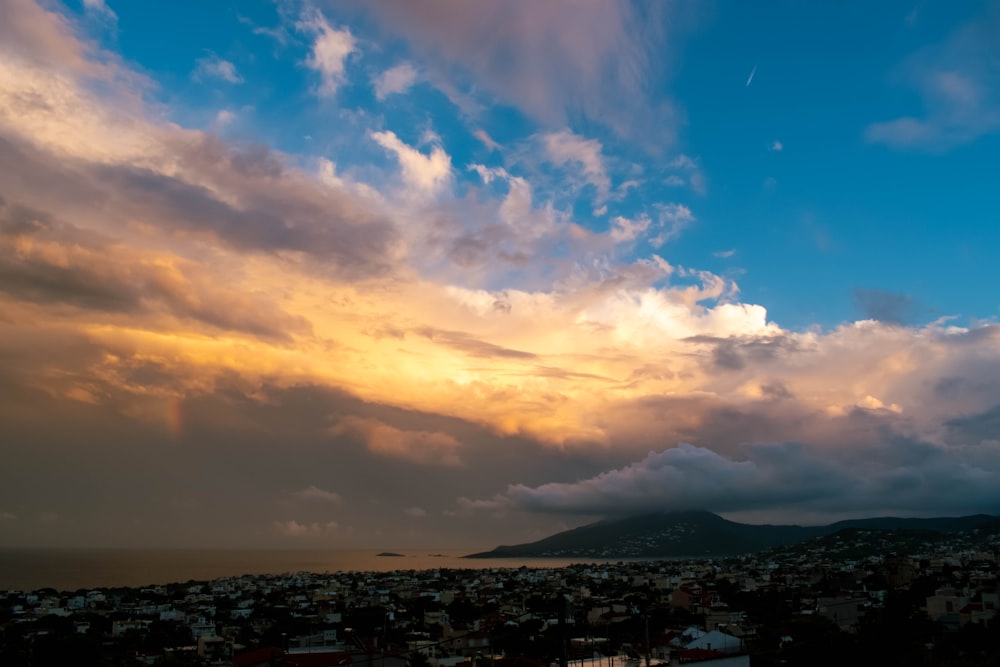 a view of a city and a body of water under a cloudy sky