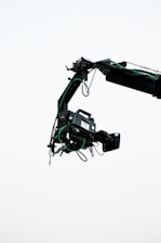 a crane is lifting a piece of equipment into the air