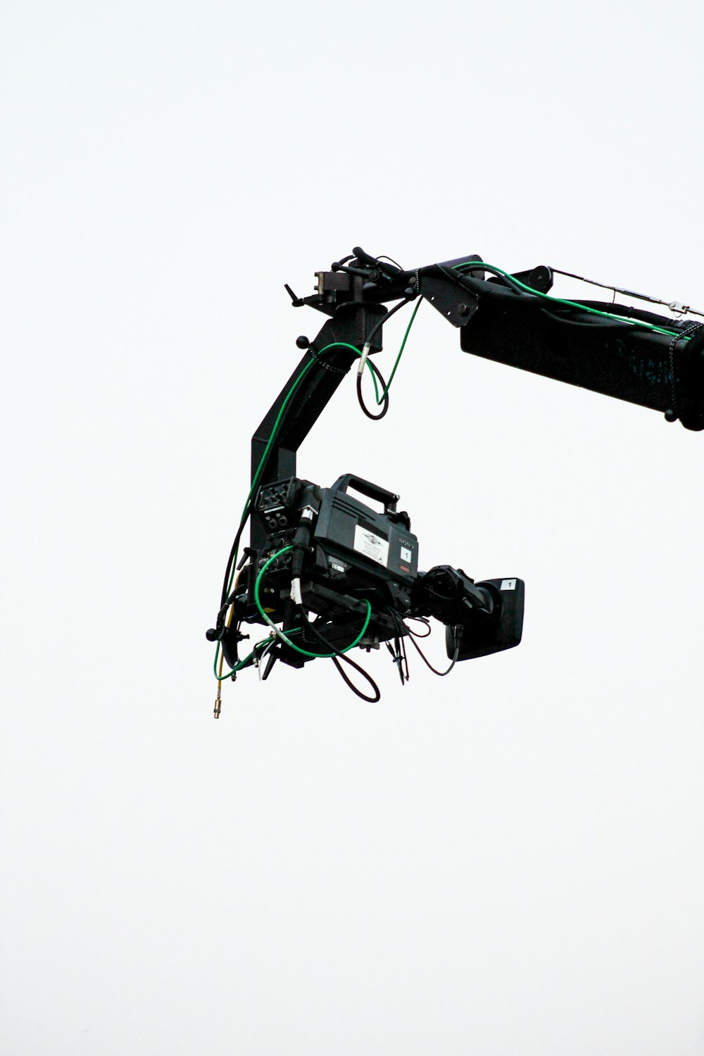 a crane is lifting a piece of equipment into the air