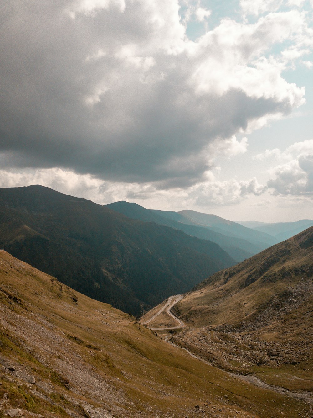 a view of a road in the middle of a mountain range