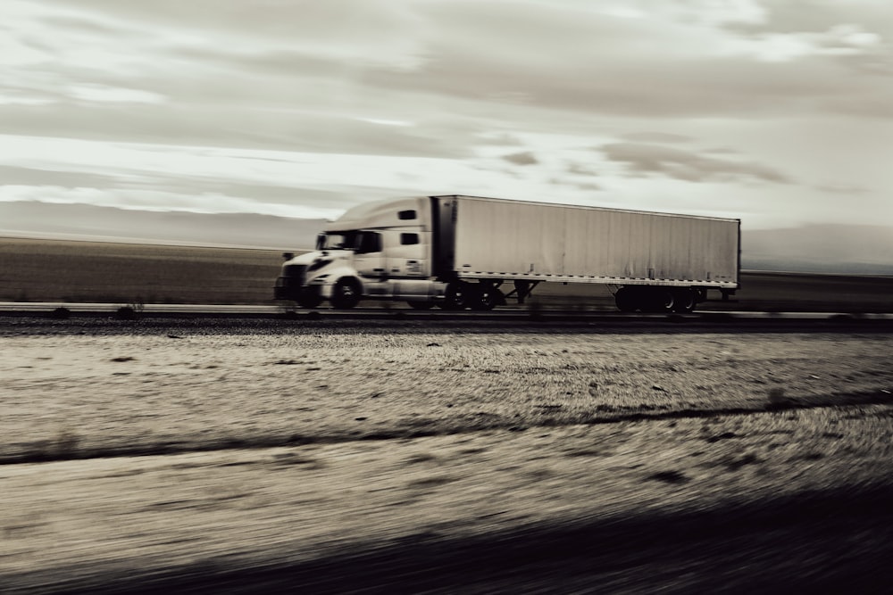 a large semi truck driving down a highway