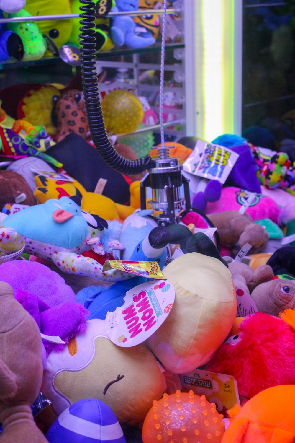 a pile of stuffed animals sitting next to a lamp