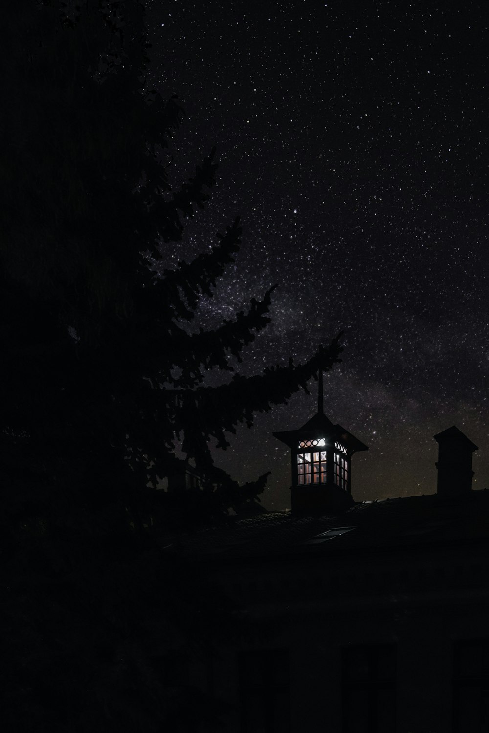 a building with a light on top of it under a night sky