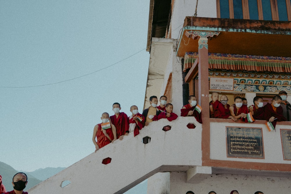 a group of people standing on top of a building