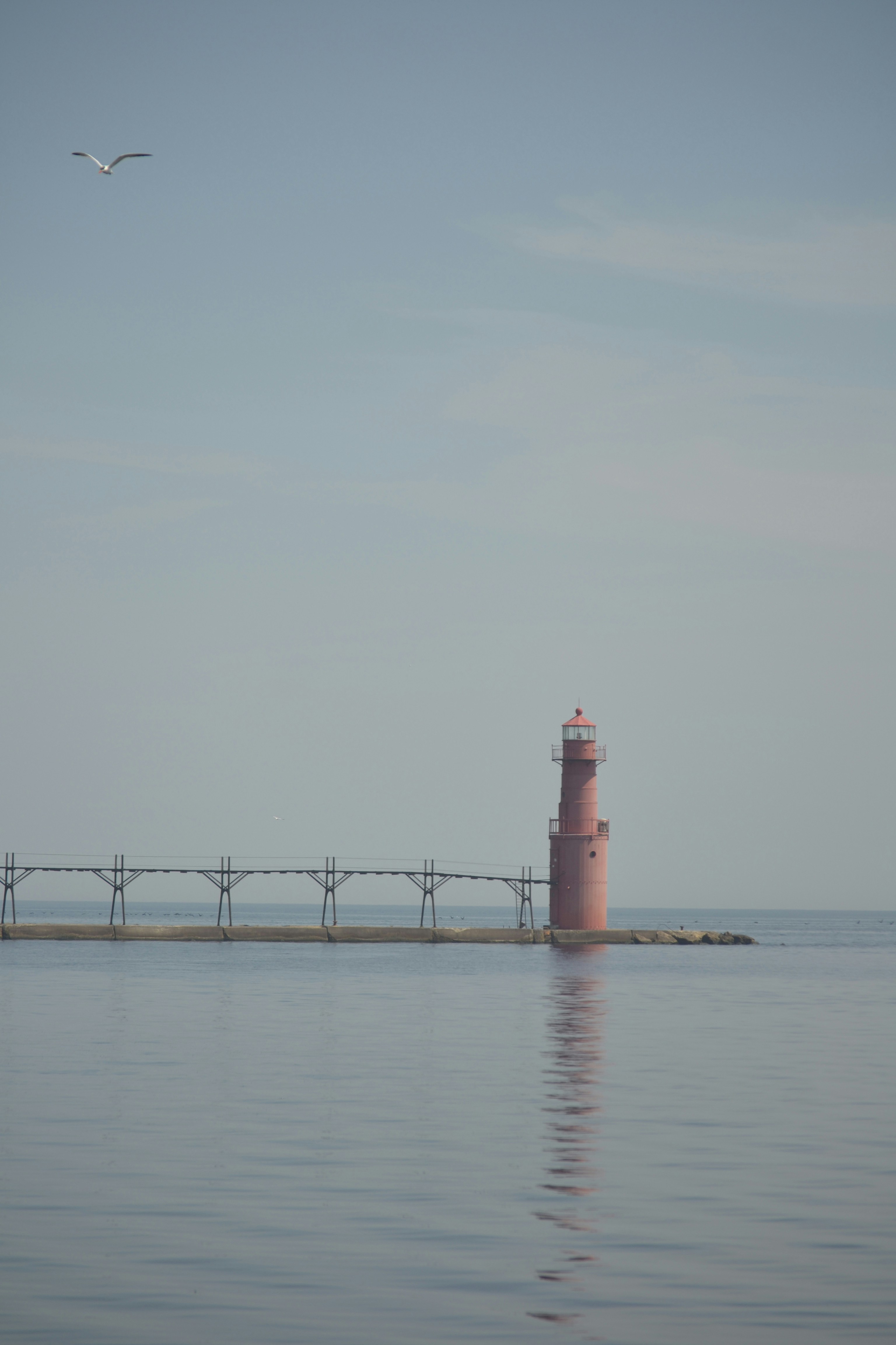a light house in the middle of a body of water