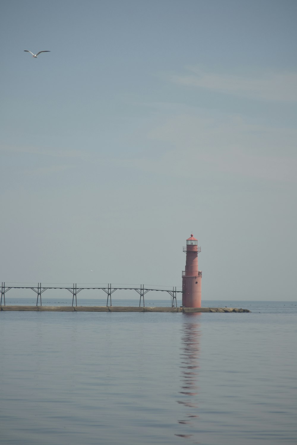 a light house in the middle of a body of water