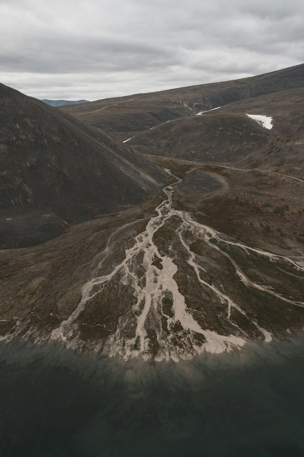 an aerial view of a river running through a valley