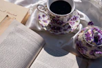a cup of coffee and a book on a table