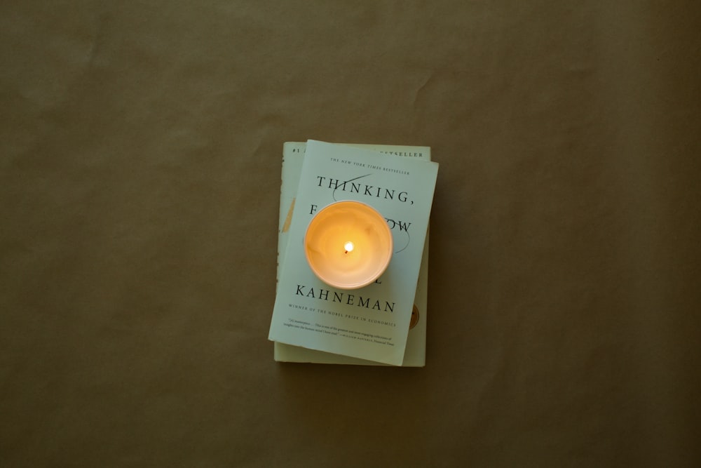 a candle sitting on top of a book