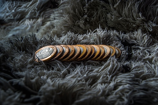 a pile of coins sitting on top of a blanket