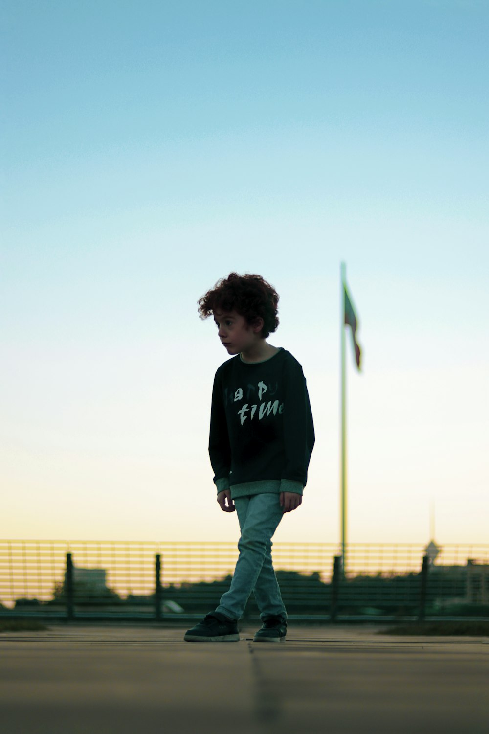 a young boy riding a skateboard down a street