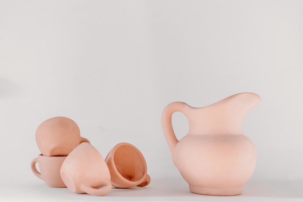 a group of three pink vases sitting next to each other