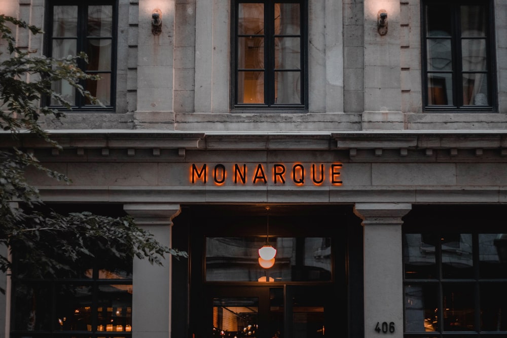 the front of a building with a neon sign on it