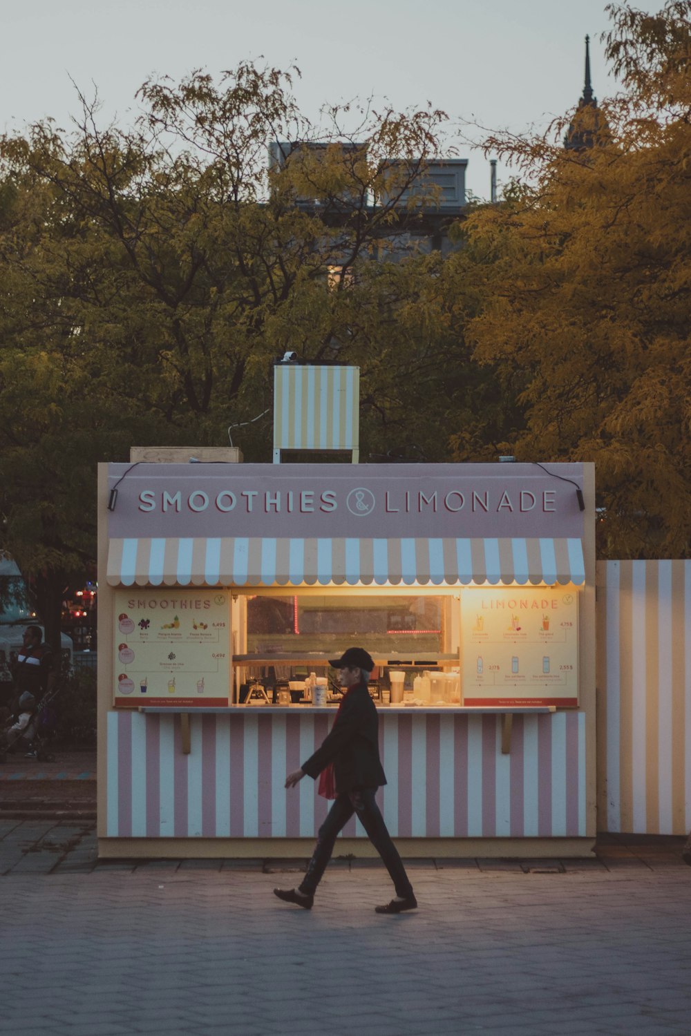 a person walking past a small food stand