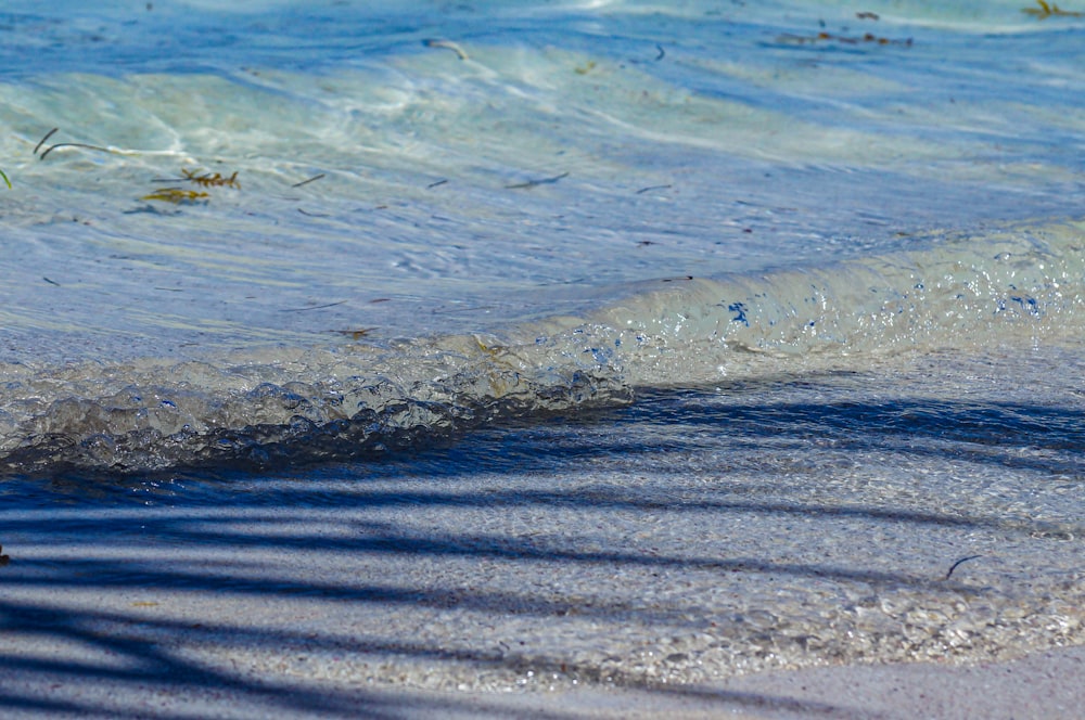 a close up of a wave on a beach