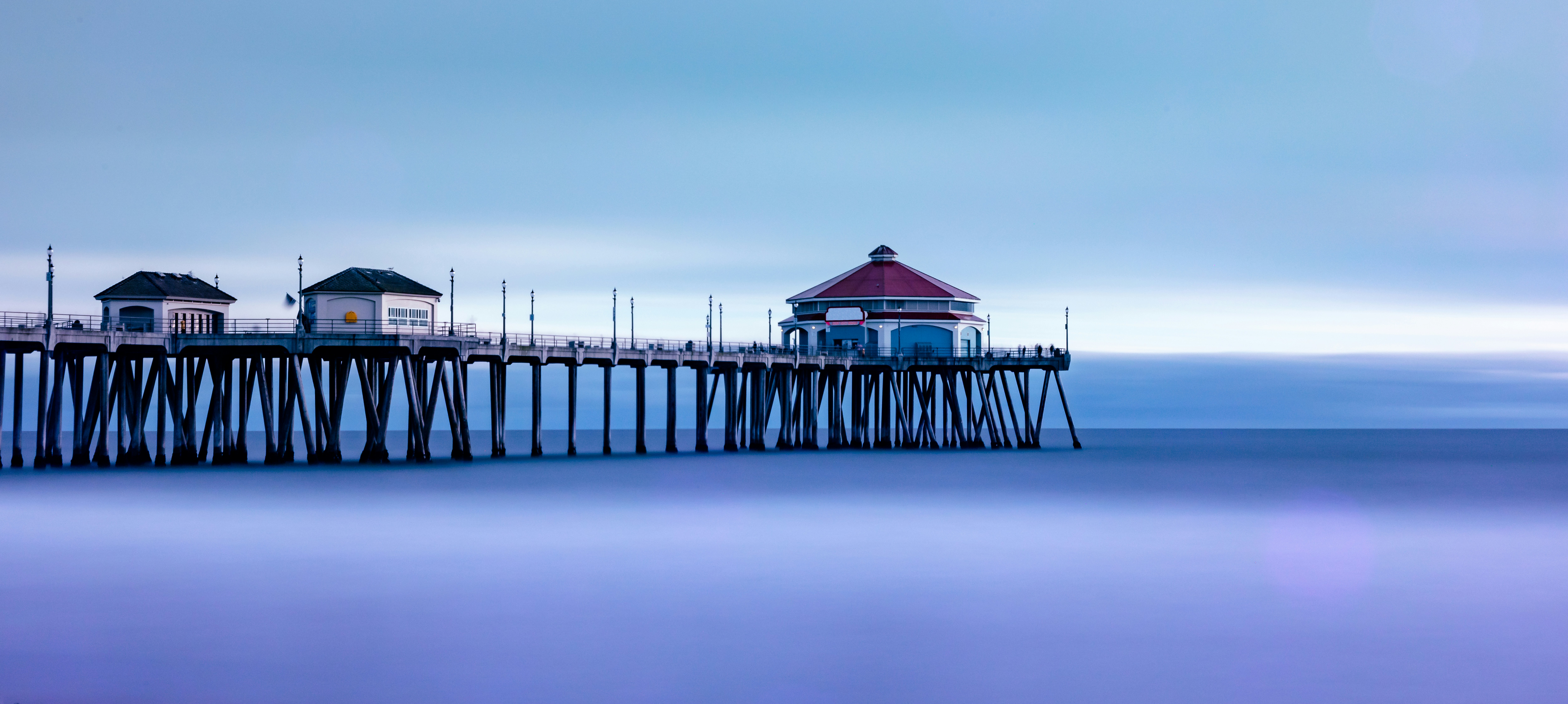 a long exposure of a pier on a foggy day