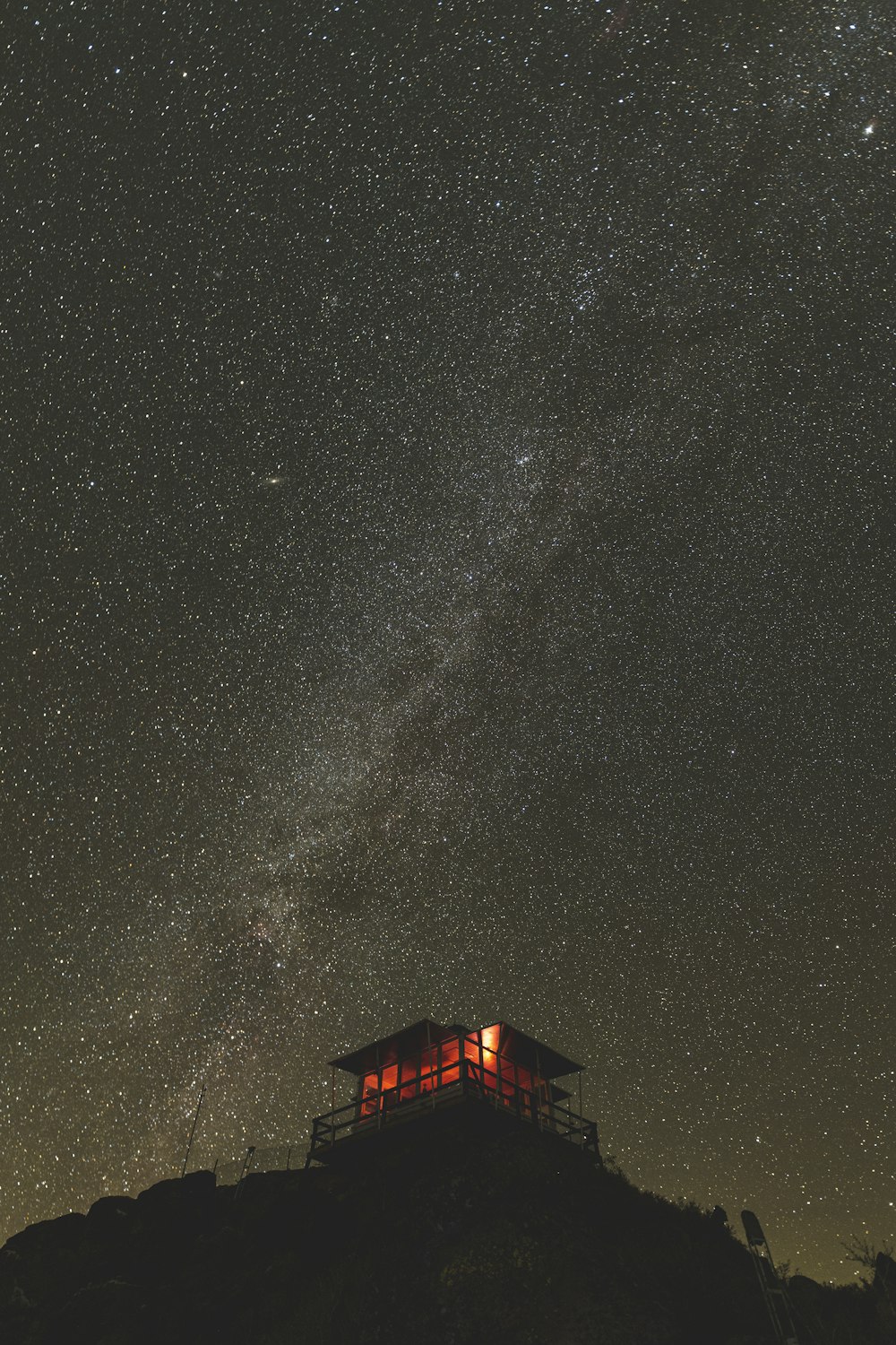 a house on a hill under a night sky