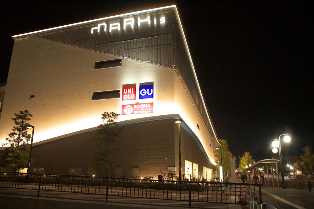 a large building with a lit up sign on it's side