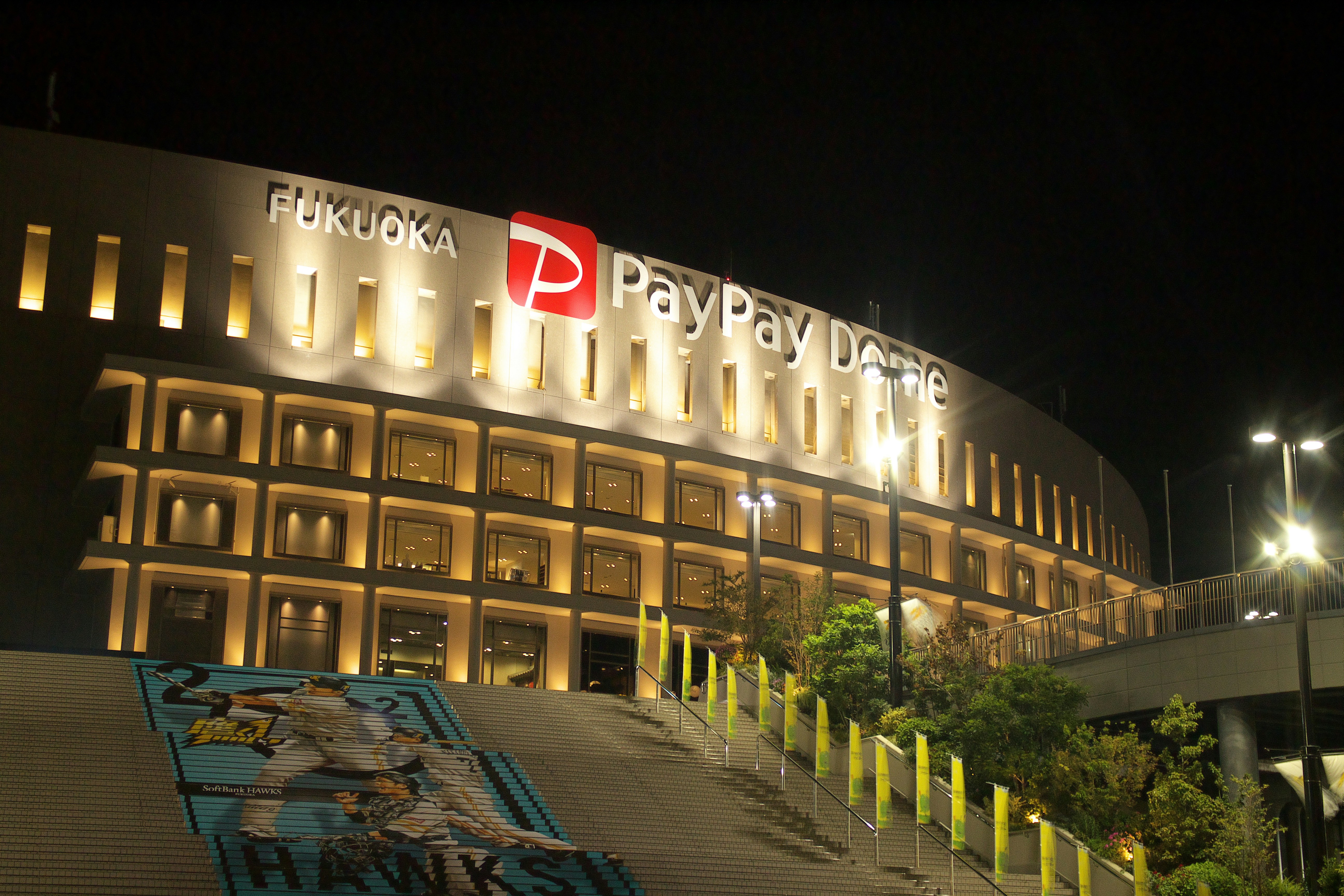 a large building with a lit up sign on top of it