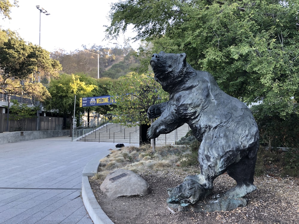 a statue of a bear is in a park