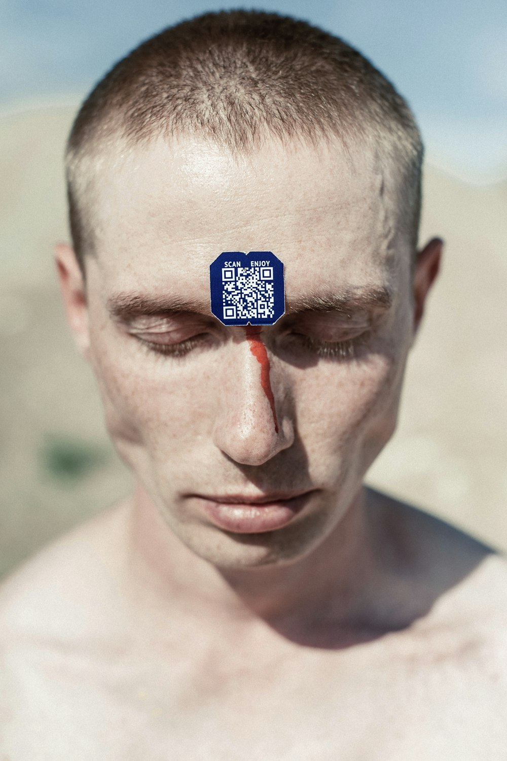 a man with a piece of tape on his forehead