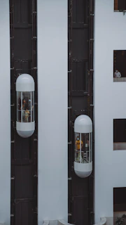 a couple of white speakers sitting next to each other