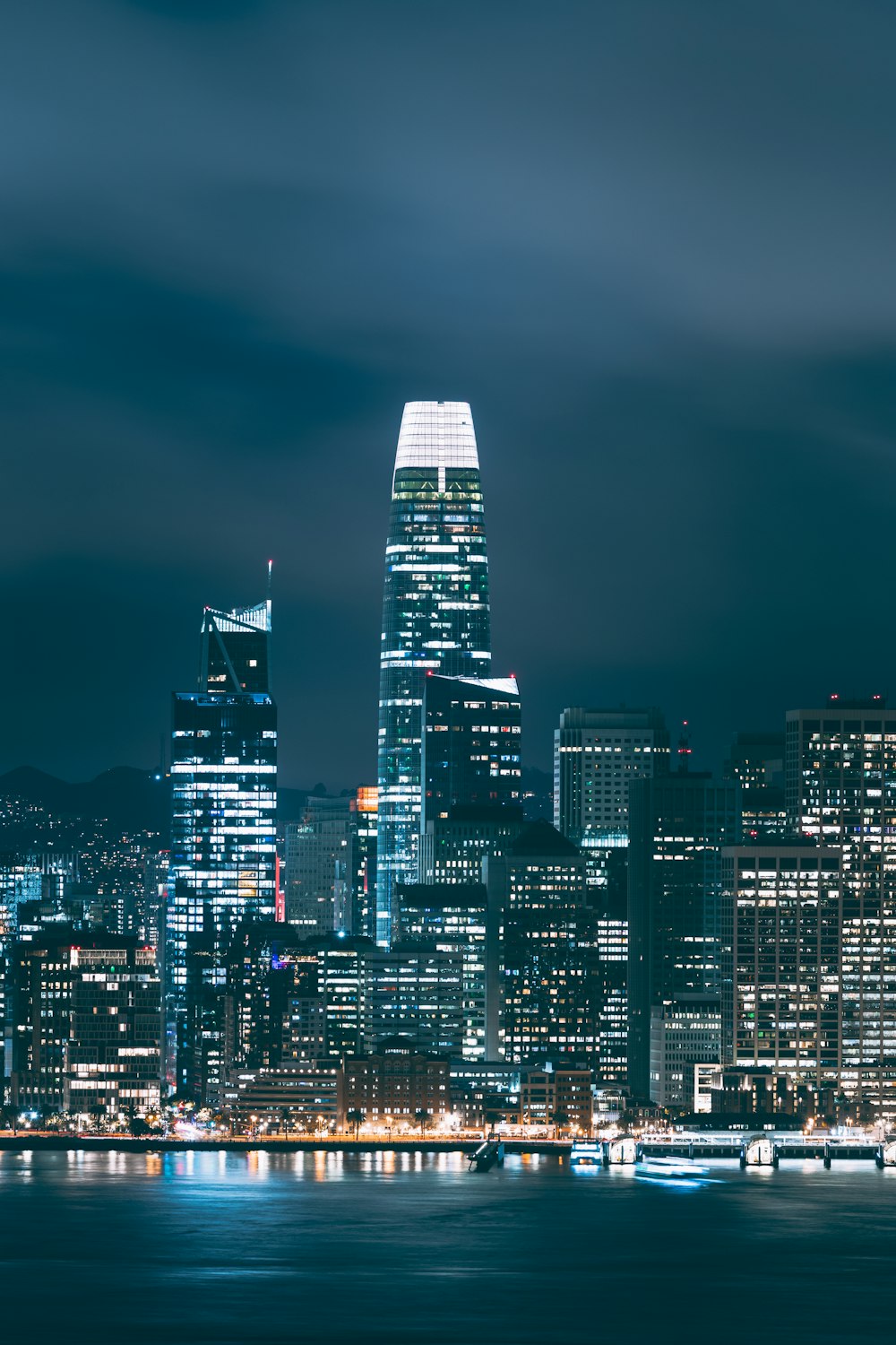 a city skyline at night with the lights on