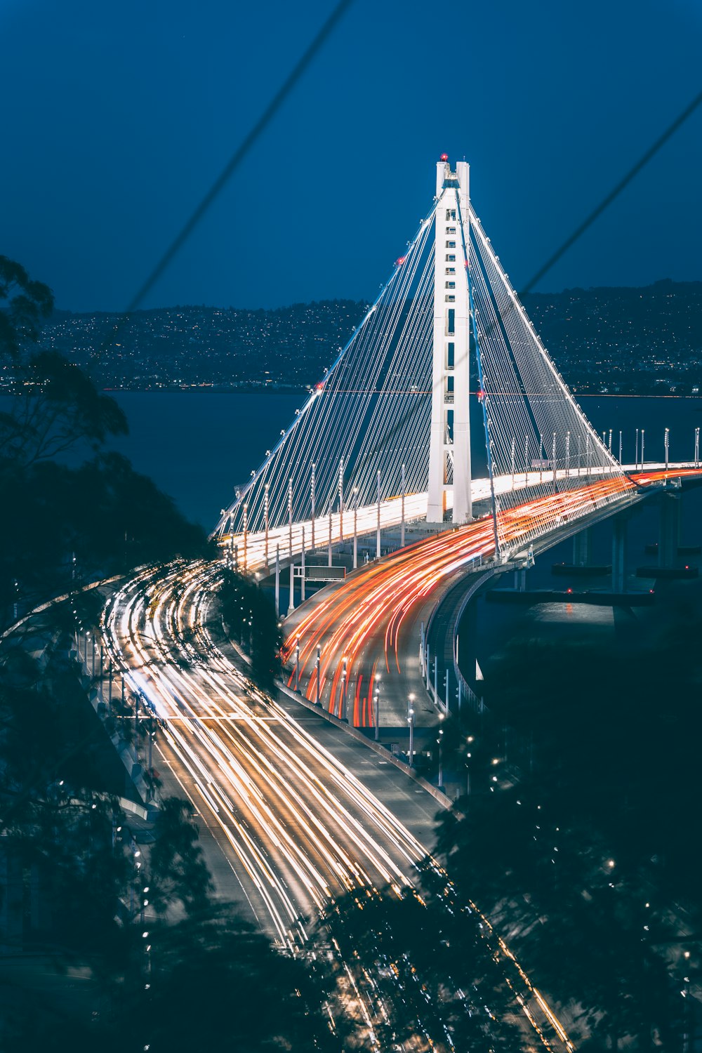 a long exposure photo of a bridge at night