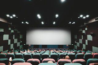 Rows of empty seats in a darkened movie theater