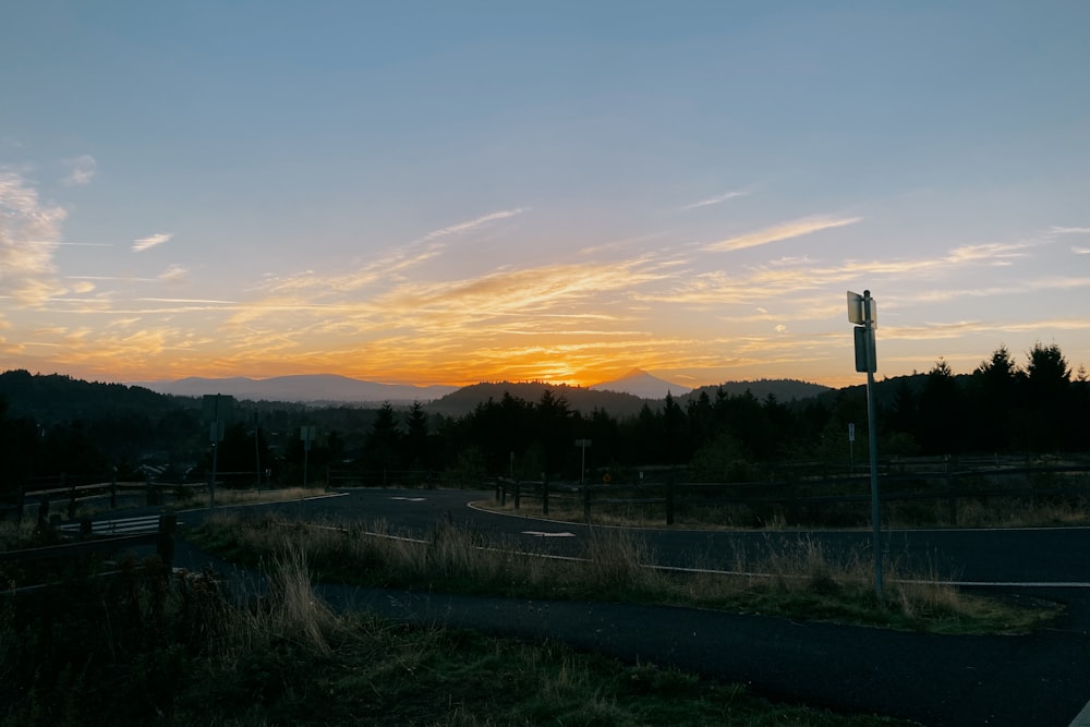 the sun is setting over the mountains in the distance