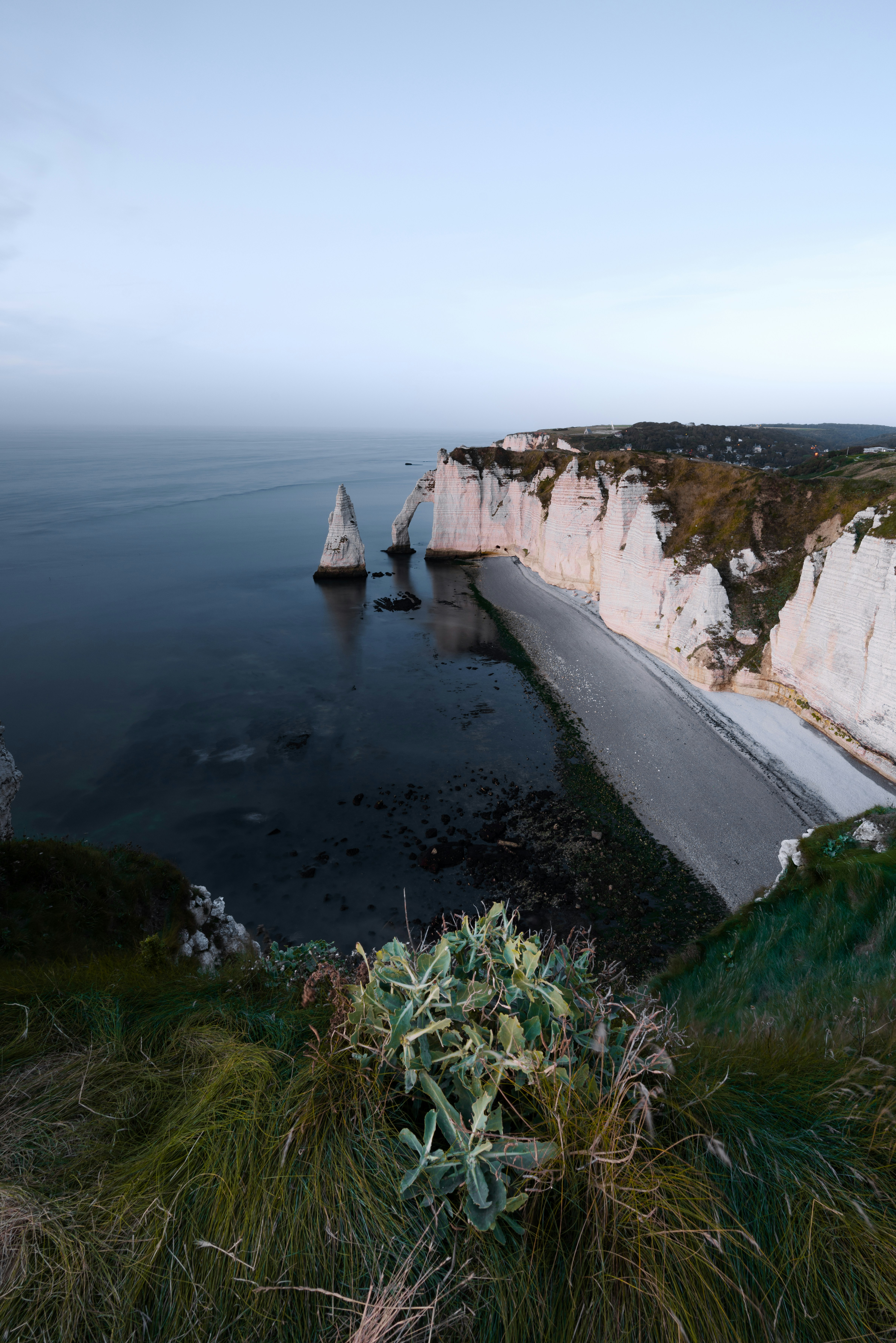 a large body of water next to a cliff
