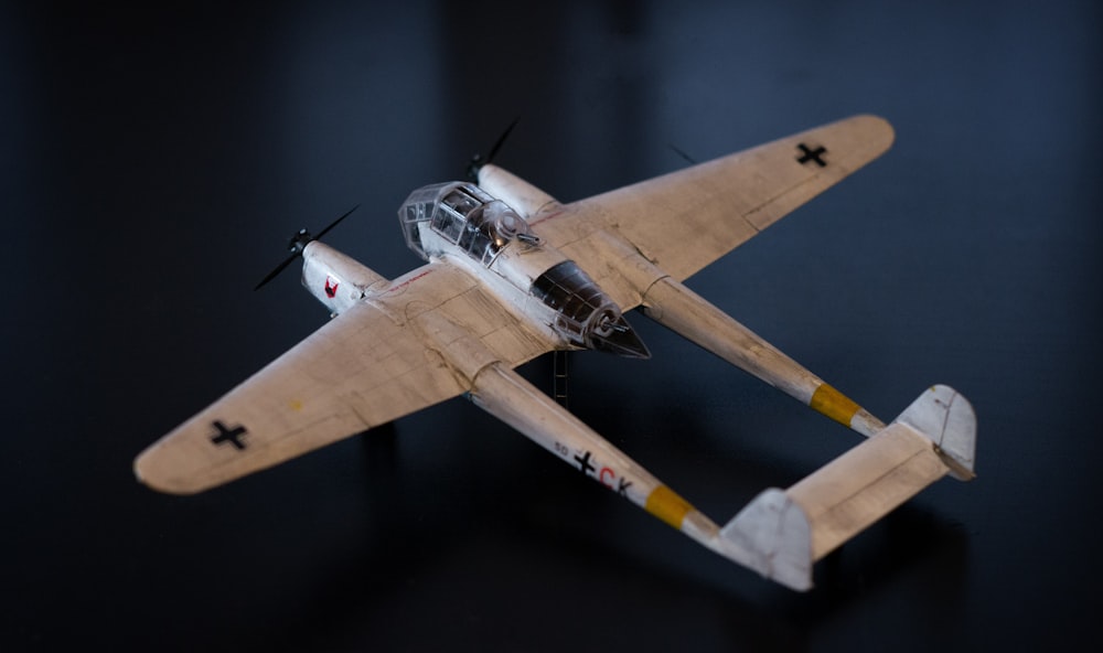 a model airplane is shown on a black surface