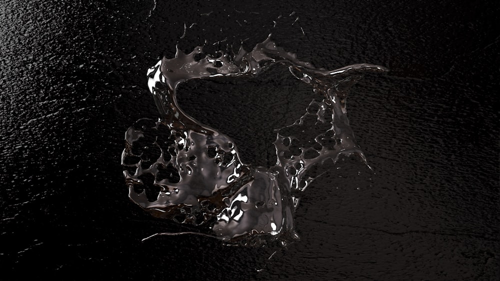 water splashing on a black surface with a black background