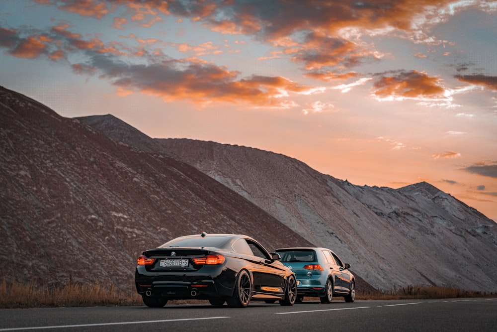 a couple of cars parked on the side of a road