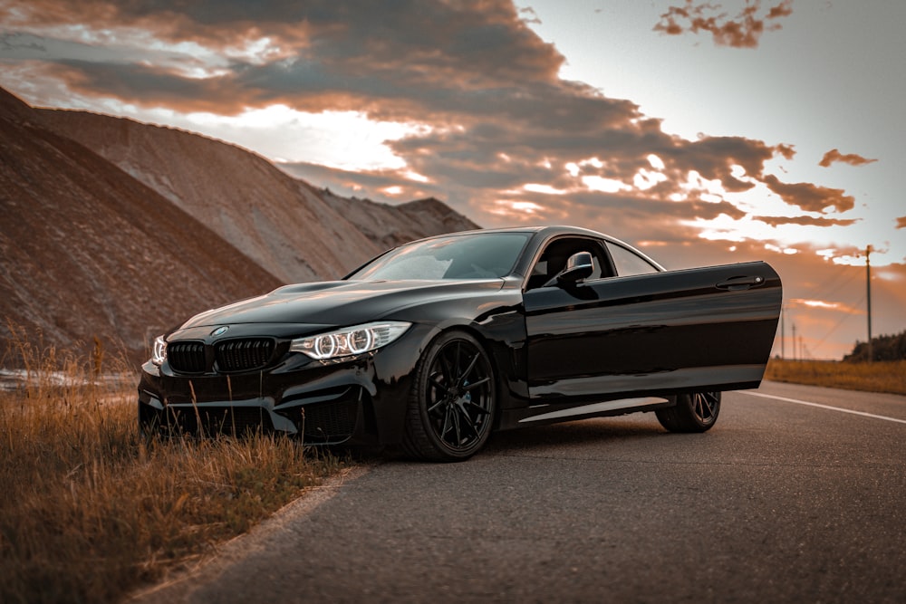 a black car parked on the side of the road