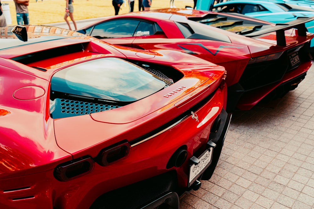 a row of red sports cars parked next to each other