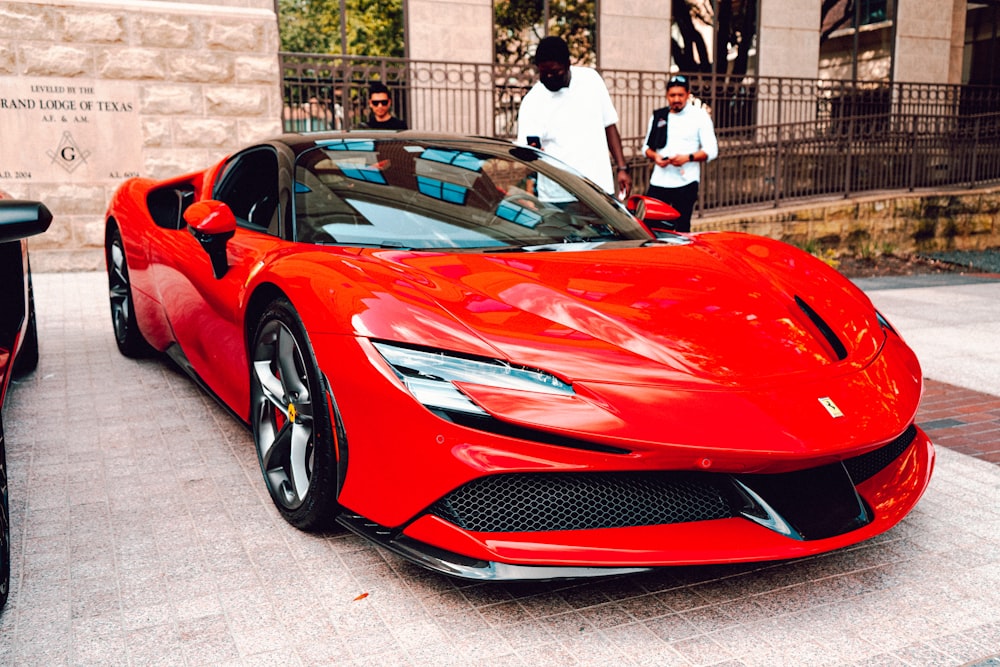 a red sports car parked in front of a building