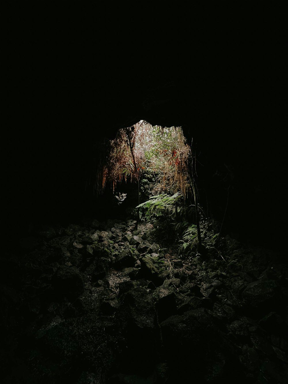 a dark cave with a light at the end of it