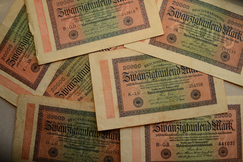 a pile of old german money sitting on top of a table