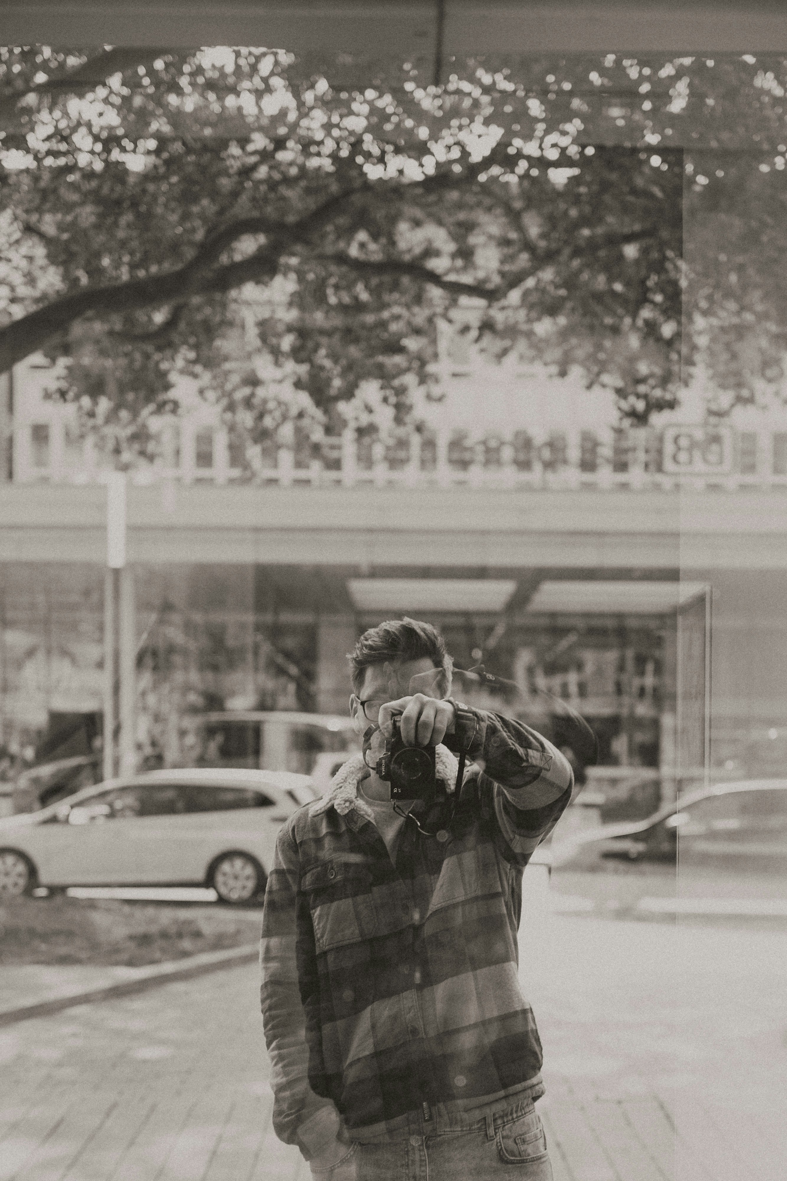 a man standing on a sidewalk talking on a cell phone